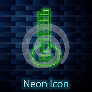 Glowing neon line Sitar classical music instrument icon isolated on brick wall background. Vector