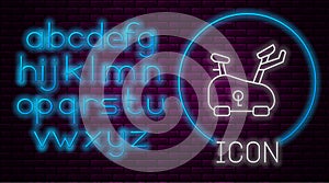 Glowing neon line Stationary bicycle icon isolated on brick wall background. Exercise bike. Neon light alphabet. Vector