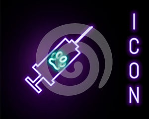 Glowing neon line Syringe with pet vaccine icon isolated on black background. Dog or cat paw print. Colorful outline