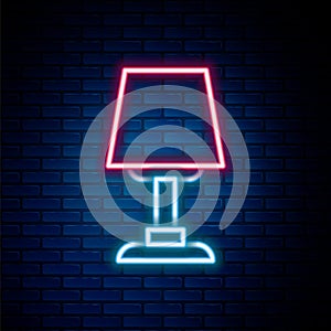 Glowing neon line Table lamp icon isolated on brick wall background. Desk lamp. Colorful outline concept. Vector