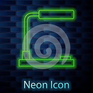 Glowing neon line Table lamp icon isolated on brick wall background. Desk lamp. Vector