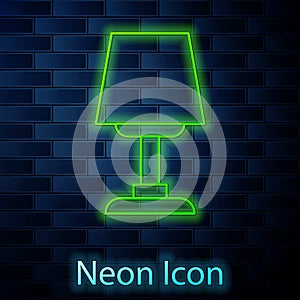 Glowing neon line Table lamp icon isolated on brick wall background. Desk lamp. Vector