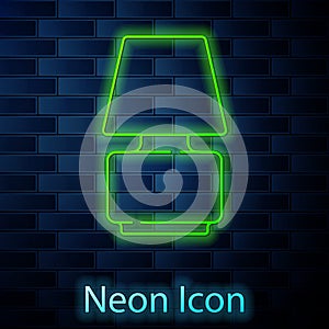 Glowing neon line Table lamp icon isolated on brick wall background. Vector