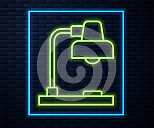 Glowing neon line Table lamp icon isolated on brick wall background. Vector