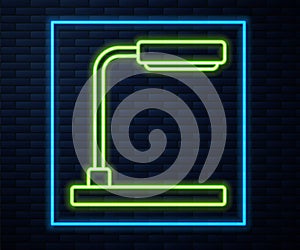 Glowing neon line Table lamp icon isolated on brick wall background. Vector