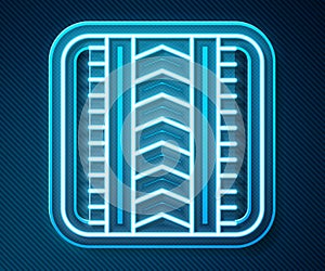 Glowing neon line Tire track icon isolated on blue background. Vector