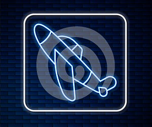 Glowing neon line Toy plane icon isolated on brick wall background. Flying airplane icon. Airliner sign. Vector