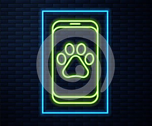 Glowing neon line Veterinary clinic symbol icon isolated on brick wall background. Cross hospital sign. A stylized paw