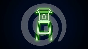 Glowing neon line Water tower icon isolated on black background. 4K Video motion graphic animation