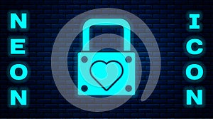 Glowing neon Lock and heart icon isolated on brick wall background. Locked Heart. Love symbol and keyhole sign