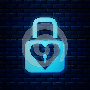Glowing neon Lock and heart icon isolated on brick wall background. Locked Heart. Love symbol and keyhole sign