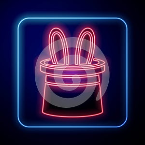 Glowing neon Magician hat and rabbit ears icon isolated on blue background. Magic trick. Mystery entertainment concept. Vector