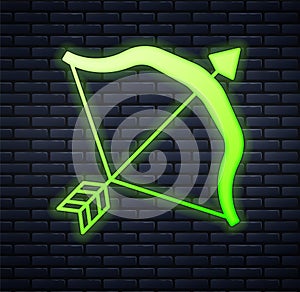 Glowing neon Medieval bow and arrow icon isolated on brick wall background. Medieval weapon. Vector