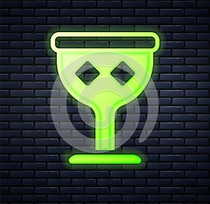 Glowing neon Medieval goblet icon isolated on brick wall background. Holy grail. Vector