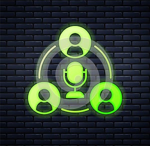 Glowing neon Meeting icon isolated on brick wall background. Business team meeting, discussion concept, analysis