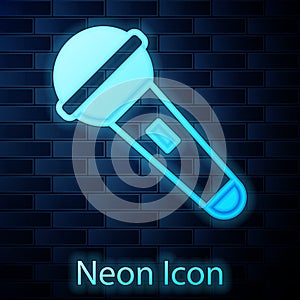 Glowing neon Microphone icon isolated on brick wall background. On air radio mic microphone. Speaker sign. Vector