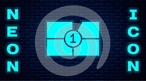 Glowing neon Old film movie countdown frame icon isolated on brick wall background. Vintage retro cinema timer count