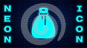 Glowing neon Old money bag icon isolated on brick wall background. Cash Banking currency sign. Vector