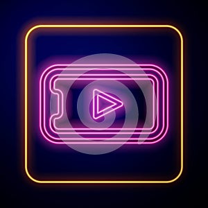 Glowing neon Online play video icon isolated on black background. Smartphone and film strip with play sign. Vector