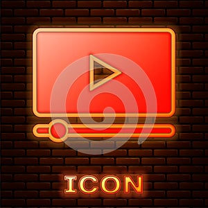 Glowing neon Online play video icon isolated on brick wall background. Film strip with play sign. Vector