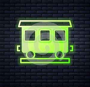 Glowing neon Passenger train cars icon isolated on brick wall background. Railway carriage. Vector