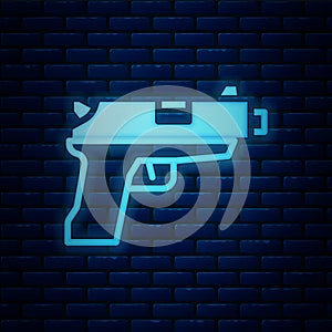 Glowing neon Pistol or gun icon isolated on brick wall background. Police or military handgun. Small firearm. Vector