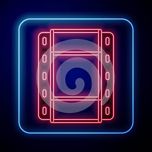 Glowing neon Play Video icon isolated on black background. Film strip sign. Vector