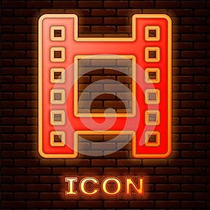 Glowing neon Play Video icon isolated on brick wall background. Film strip sign. Vector