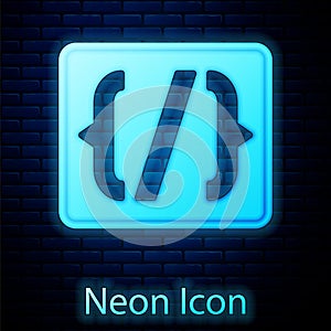 Glowing neon Programming language syntax icon isolated on brick wall background. Syntax programming file system. Vector