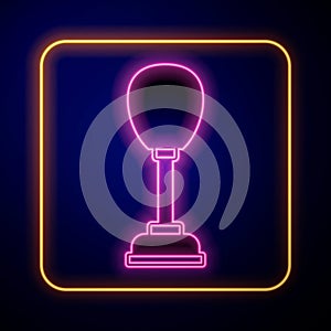 Glowing neon Punching bag icon isolated on black background. Vector