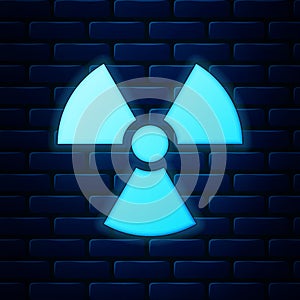 Glowing neon Radioactive icon isolated on brick wall background. Radioactive toxic symbol. Radiation Hazard sign. Vector