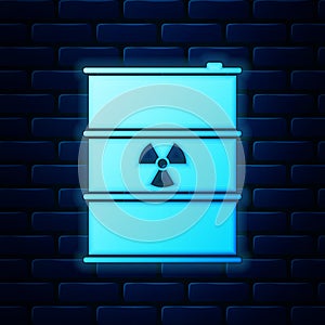 Glowing neon Radioactive waste in barrel icon isolated on brick wall background. Radioactive garbage emissions