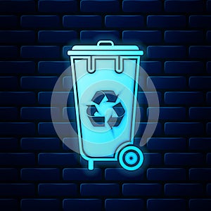 Glowing neon Recycle bin with recycle symbol icon isolated on brick wall background. Trash can icon. Garbage bin sign