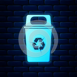 Glowing neon Recycle bin with recycle symbol icon isolated on brick wall background. Trash can icon. Garbage bin sign