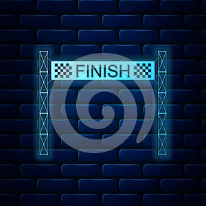 Glowing neon Ribbon in finishing line icon isolated on brick wall background. Symbol of finish line. Sport symbol or