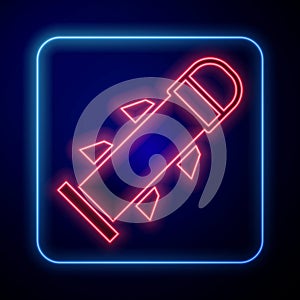 Glowing neon Rocket icon isolated on blue background. Vector