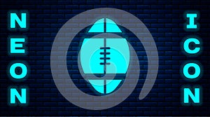 Glowing neon Rugby ball icon isolated on brick wall background. Vector