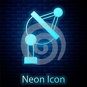 Glowing neon Satellite dish icon isolated on brick wall background. Radio antenna, astronomy and space research. Vector