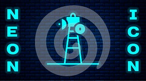 Glowing neon Satellite dish icon isolated on brick wall background. Radio antenna, astronomy and space research. Vector