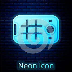 Glowing neon Selfie on mobile phone icon isolated on brick wall background. Vector