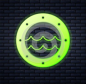 Glowing neon Ship porthole with rivets and seascape outside icon isolated on brick wall background. Vector