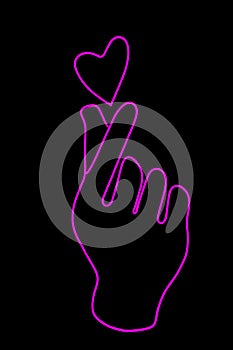 Glowing neon sign of a the fingers make a heart isolated on a black background. Korean style