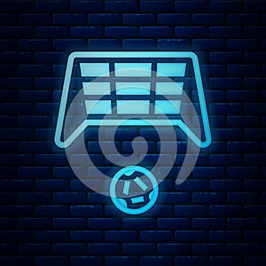 Glowing neon Soccer goal with ball icon isolated on brick wall background. Vector
