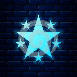 Glowing neon Star icon isolated on brick wall background. Favorite, Best Rating, Award symbol. Vector