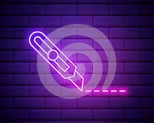 Glowing neon Stationery knife icon isolated on brick wall background. Office paper cutter. Vector Illustration