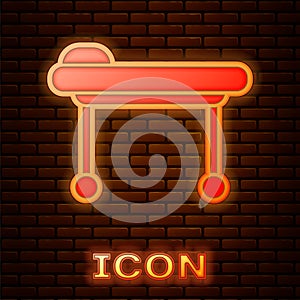 Glowing neon Stretcher icon isolated on brick wall background. Patient hospital medical stretcher. Vector Illustration