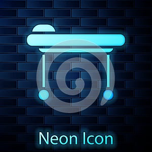 Glowing neon Stretcher icon isolated on brick wall background. Patient hospital medical stretcher. Vector Illustration