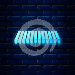 Glowing neon Striped awning icon isolated on brick wall background. Outdoor sunshade sign. Awning canopy for shops