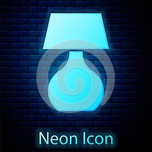 Glowing neon Table lamp icon isolated on brick wall background. Desk lamp. Vector