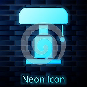 Glowing neon Table lamp icon isolated on brick wall background. Vector